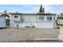 Exterior view of a well-maintained mobile home featuring clean gravel landscaping at 1366 Shipwreck Ln, Saint Cloud, FL 34771