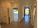 Open foyer showcasing tile floors and access to garage and backyard at 2453 Shiprock Ct, Deltona, FL 32738