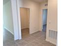 Bright hallway with tile floors and access to several rooms at 2453 Shiprock Ct, Deltona, FL 32738