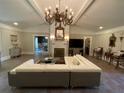 Spacious living room featuring a large sectional sofa and ornate chandelier at 5021 Harbor Hts, Lady Lake, FL 32159