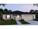 Newly built home with gray siding, two-car garage, and front yard landscaping at 2229 Elegant Manor Cir, Edgewater, FL 32141