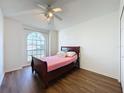 Cozy bedroom with wood-look floors and a double bed at 3507 Tenby Cir, Clermont, FL 34711