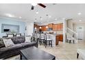 Open concept living room with view of the kitchen featuring an island and stainless steel appliances at 2054 Rome Dr, Kissimmee, FL 34747