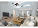 Spacious, open-concept living room with vaulted ceilings, modern furniture, and lots of natural light at 2205 Cypress Cove Dr, Tavares, FL 32778