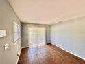 Versatile empty room featuring tile flooring, a window, and sliding glass door at 544 S Cottage Hill Rd, Orlando, FL 32805