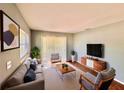 Bright living room featuring stylish furnishings, large windows, and a neutral color palette at 544 S Cottage Hill Rd, Orlando, FL 32805
