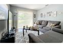 Inviting living room with comfortable seating, modern decor, and a sliding glass door to the backyard at 544 S Cottage Hill Rd, Orlando, FL 32805