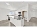 Bright kitchen with granite countertops, stainless steel appliances, and a center island at 2633 Hancock Crossing Dr, Bartow, FL 33830