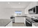 Bright kitchen featuring granite counters, stainless steel appliances, and ample cabinet space at 2633 Hancock Crossing Dr, Bartow, FL 33830