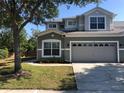 Two-story house with gray exterior, attached garage, and landscaped lawn at 416 Canyon Stone Cir, Lake Mary, FL 32746