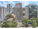 Expansive city view of a modern building, surrounded by lush trees and bustling city streets at 322 E Central Blvd # 401, Orlando, FL 32801