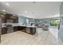 Modern kitchen with dark cabinetry and expansive island at 8831 Interlocking Ct, Davenport, FL 33896