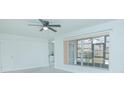 Bright bedroom with large window, ceiling fan, and view at 1048 Plantation Dr # E-9, Kissimmee, FL 34741