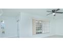 Living room featuring large window and ceiling fan at 1048 Plantation Dr # E-9, Kissimmee, FL 34741