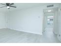 Living area with wood-look floors and access to other rooms at 1048 Plantation Dr # E-9, Kissimmee, FL 34741