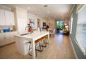 Open concept kitchen with island seating and views to living area at 5575 Maddie Dr, Haines City, FL 33845