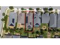Aerial view of a home with solar panels, a green backyard, and a well-maintained roof and lawn at 4904 W Fountainwood Dr, St Cloud, FL 34772