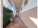 Inviting front entrance featuring a decorative door, brick pavers, and verdant landscaping at 4904 W Fountainwood Dr, St Cloud, FL 34772