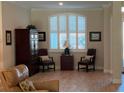 Cozy den with modern furniture, wood look floors, and a tranquil window with plantation shutters at 3962 Kennebunk Loop, Mount Dora, FL 32757
