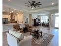 Spacious living area featuring wood floors, a ceiling fan, and modern lighting at 3962 Kennebunk Loop, Mount Dora, FL 32757