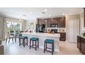 Open kitchen featuring large island, stainless steel appliances, and modern finishes at 2755 San Marco Way, Winter Haven, FL 33884