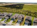 New homes boast lush landscaping and views of verdant fields and mature groves at 7367 Catania Loop, Clermont, FL 34714