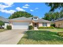 Attractive single-story home with a neat lawn and garage at 4223 Arlington Ridge Blvd, Leesburg, FL 34748