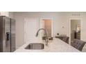 Granite countertop kitchen island with a stainless steel sink and faucet at 704 Village Ct, Fruitland Park, FL 34731