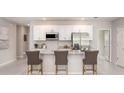 Modern kitchen featuring stainless steel appliances and an island with seating at 704 Village Ct, Fruitland Park, FL 34731