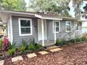 Charming renovated cottage with fresh gray paint, landscaping, and curb appeal at 4790 Anderson Rd, Orlando, FL 32812