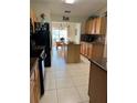 Open kitchen with stainless steel appliances, an 'EAT' sign, and adjoining dining area at 1201 Thornbury Ct, Winter Garden, FL 34787