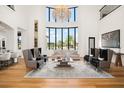 Bright living room boasts soaring ceilings, large windows, and stylish furnishings at 4029 Isabella Cir, Windermere, FL 34786