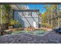Private backyard with a waterfall feature cascading into a refreshing pool, set against a blue home exterior at 809 E Ridgewood St, Orlando, FL 32803