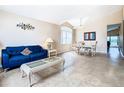 Open-concept living room and dining area featuring neutral paint, tile floors, and ample natural light at 215 Riggs Cir, Davenport, FL 33897