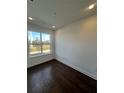 Bright bedroom with dark hardwood floors and large window at 2018 Packing District Way, Orlando, FL 32804
