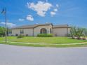 Well-maintained home with a spacious front yard, complemented by mature trees and green landscaping at 745 Asturias Rd, Davenport, FL 33837