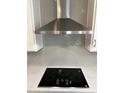 Modern glass top range with stainless steel Samsung vent hood at 4922 Shady Pines Dr, Saint Cloud, FL 34772