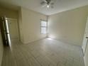 Clean bedroom featuring tiled floors, a ceiling fan and a window at 5156 City St # 118, Orlando, FL 32839