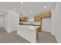 Modern kitchen with white countertops, island, and stainless steel appliances at 8377 Wilder Pines Ave, Lakeland, FL 33809