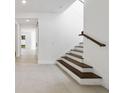 Bright entryway with wood staircase and a view to the backyard through an open doorway at 231 Severn Way # 36, Orlando, FL 32803