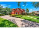 Two-story house with red brick and a paved driveway at 2107 Westover Reserve Blvd, Windermere, FL 34786