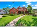 Two-story house with red brick and a landscaped lawn at 2107 Westover Reserve Blvd, Windermere, FL 34786