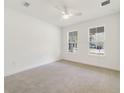 Bright bedroom with neutral carpet, a ceiling fan, and lots of natural light at 2138 Forest Cir # 32, Orlando, FL 32803