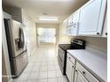 Bright kitchen features stainless steel appliances and white cabinets at 3844 Eversholt St, Clermont, FL 34711