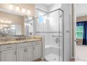 Elegant bathroom featuring a large walk-in shower and granite vanity at 737 Alcove Dr, Groveland, FL 34736