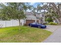 Two-story house with a double garage and a blue car parked in the driveway at 222 Emmy Cv, Oviedo, FL 32765