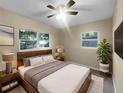 Cozy bedroom features a plush bed, soft lighting, and large windows with peaceful views at 122 Club Rd, Sanford, FL 32771