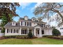 Beautiful two-story home featuring a manicured lawn, classic black shutters, and elegant architectural details at 1860 Via Contessa, Winter Park, FL 32789