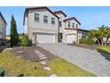 Two-story home with stone accents and a three-car garage at 16829 Bolsena Dr, Montverde, FL 34756