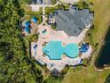 Overhead shot of the community pool, playground, clubhouse, and lounge area, surrounded by lush greenery at 17843 Golden Leaf Ln, Orlando, FL 32820